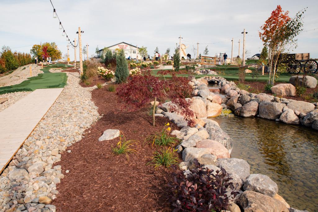 Boardwalk beside the pond with the course and buildings behind
