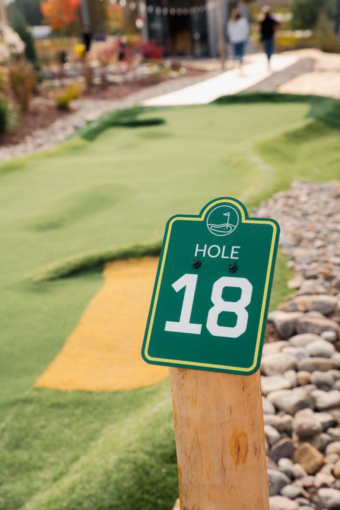 Hole eighteen marker on a cedar post beside the green