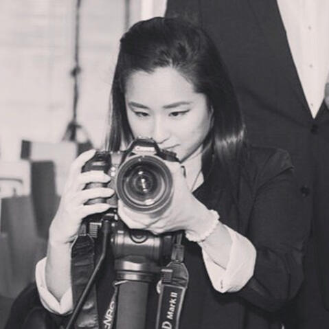 Rosa Park photographing on a tripod-mounted camera, black and white portrait